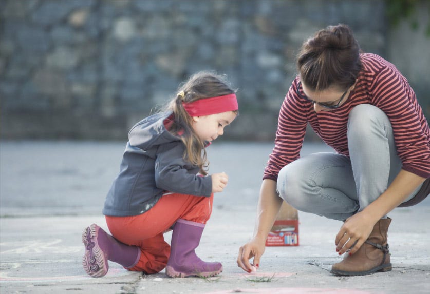 Mother and daughter playing outside - how to explain mosquito bites to your kids